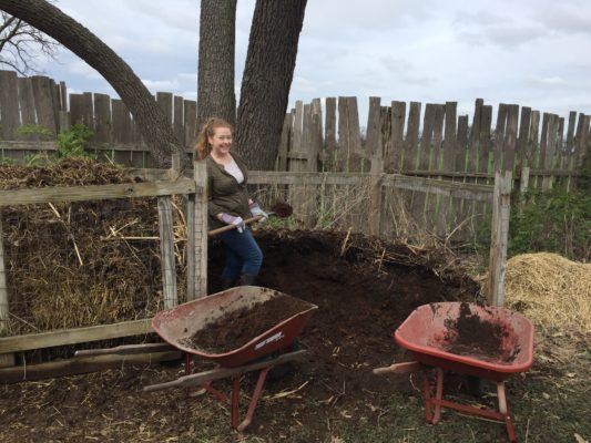 Volunteer shoveling compost