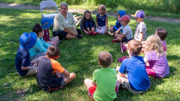 Author Teresa Peterson reads her book Grasshopper Girl to campers.