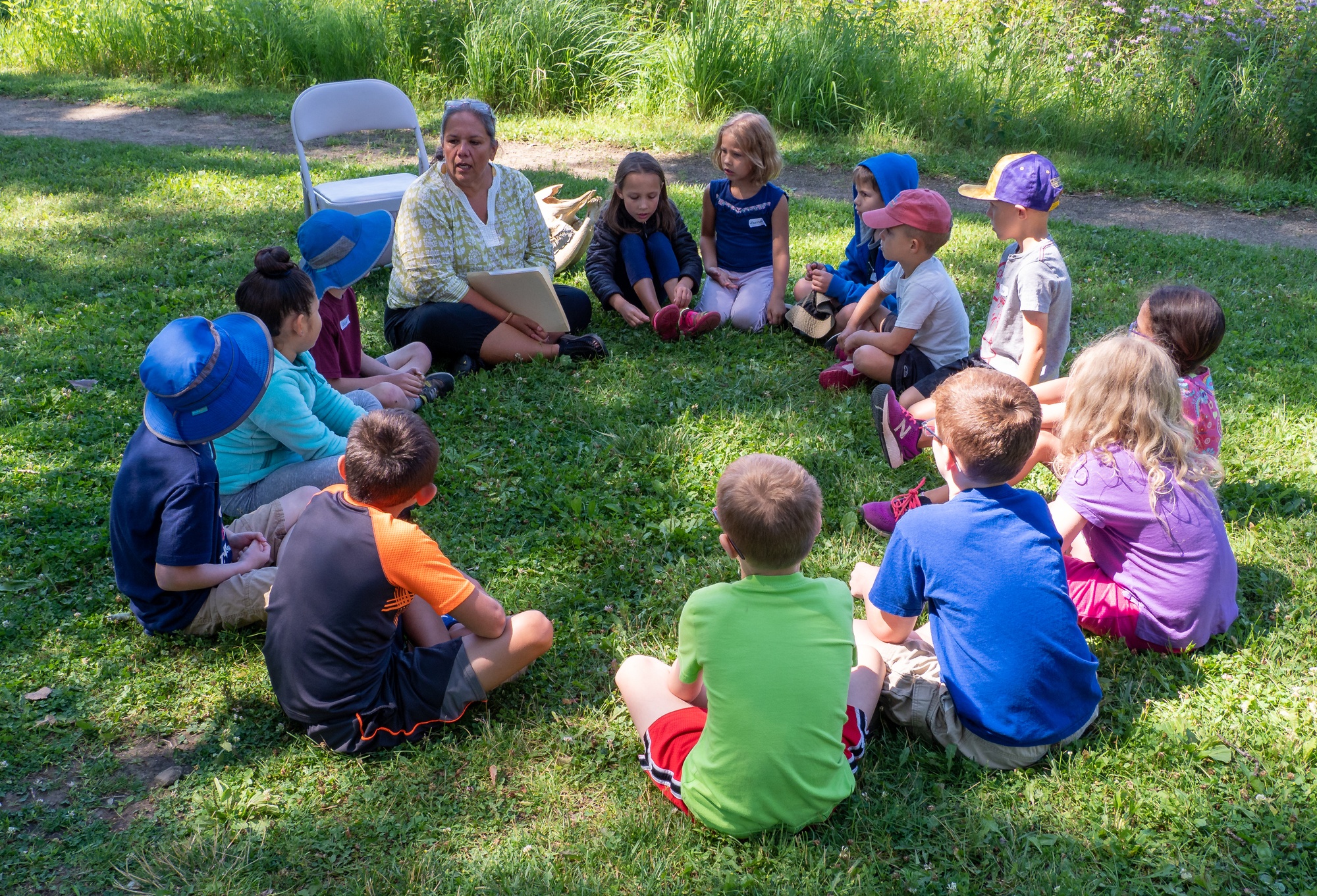 Author Teresa Peterson reads her book Grasshopper Girl to campers.