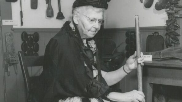 Mrs Ethel Stewart with a butter churn in historic costume